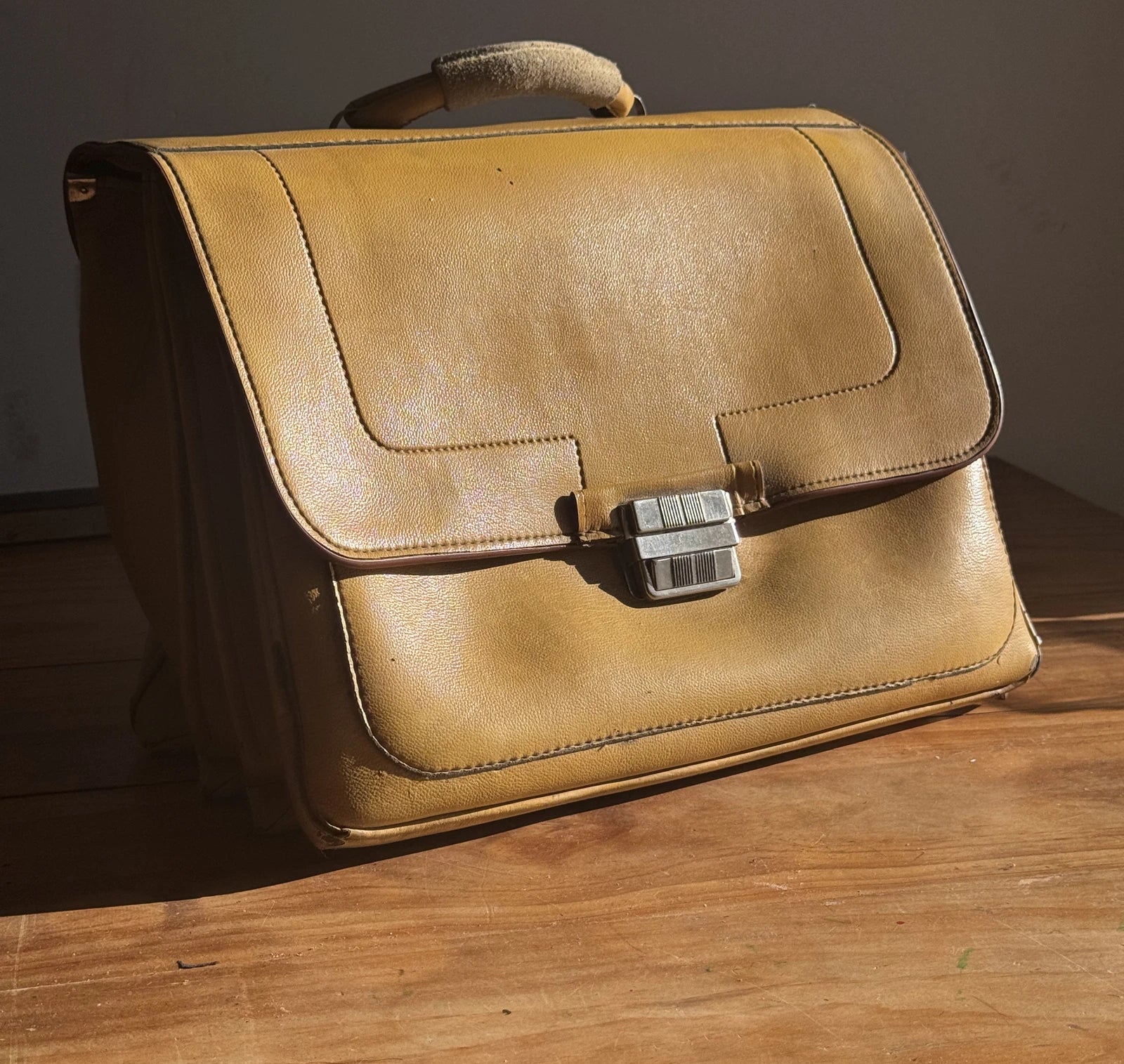 The original yellow faux-leather briefcase, preserved by the family