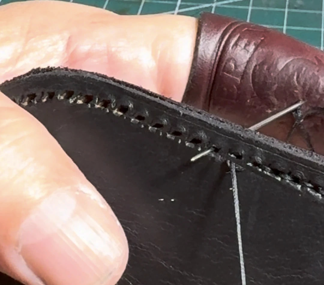 A close view of hand stitching along a leather edge